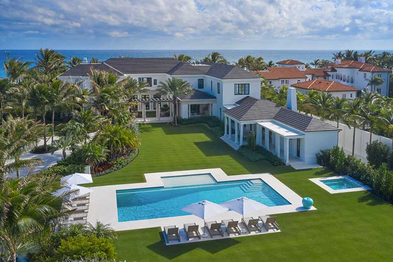 an estate with large house, pool and garden