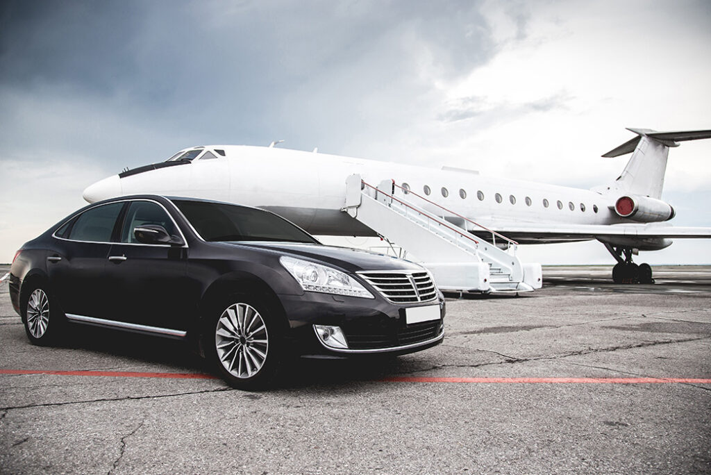 a valet car in front of a private jet on the tarmac